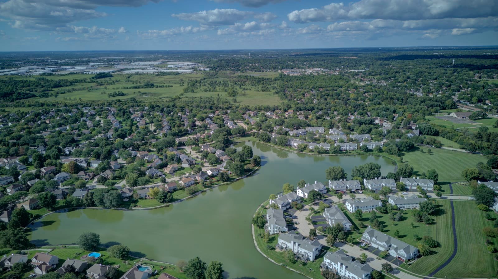 Woodland Hills Bartlett IL aerial showing the townhome courts along the lake and the open space to the east